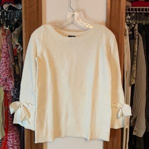 Cream boat neck sweater with bow detail on sleeves